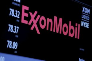 The logo of Exxon Mobil Corporation is shown on a monitor above the floor of the New York Stock Exchange in New York